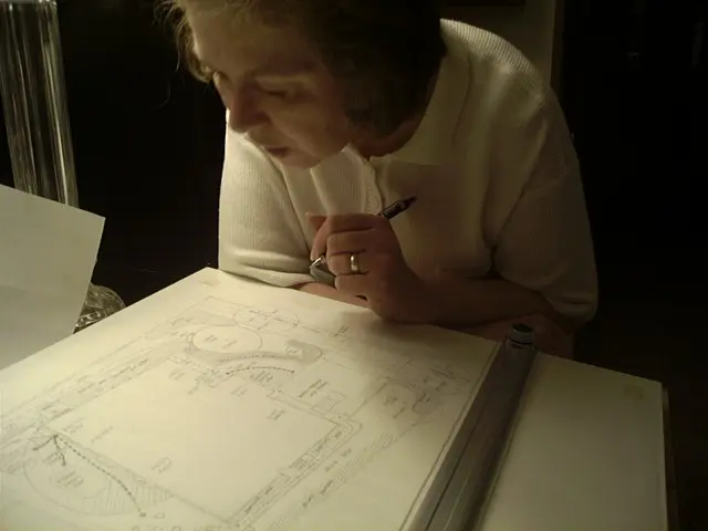 67ec97e9a747d_Pic 2 044 A woman is drawing on paper with a pencil.
